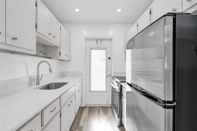 a kitchen with a stove and white cabinets