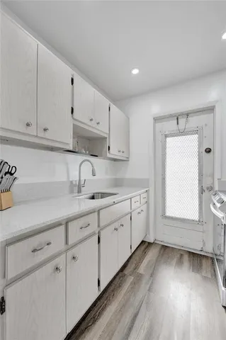 a stove top oven sitting inside of a kitchen