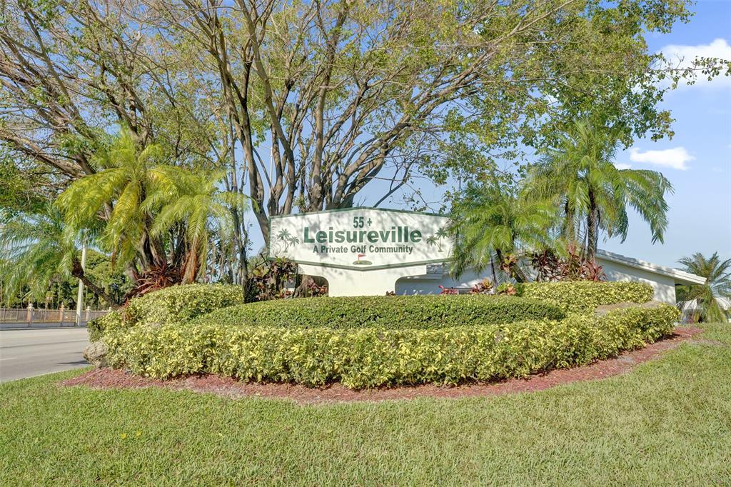 2751 East Golf Boulevard, Unit 2019 Pompano Beach, FL 33064 - Photo 3 of 68 a view of a garden with large trees