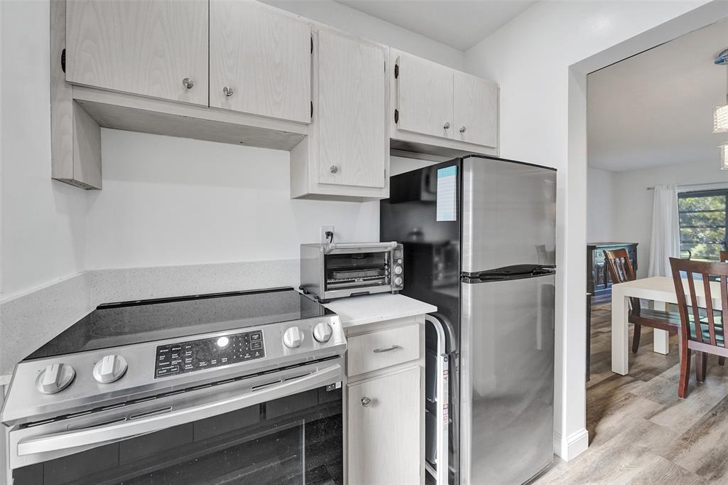 2751 East Golf Boulevard, Unit 2019 Pompano Beach, FL 33064 - Photo 36 of 68 a stove top oven sitting inside of a kitchen