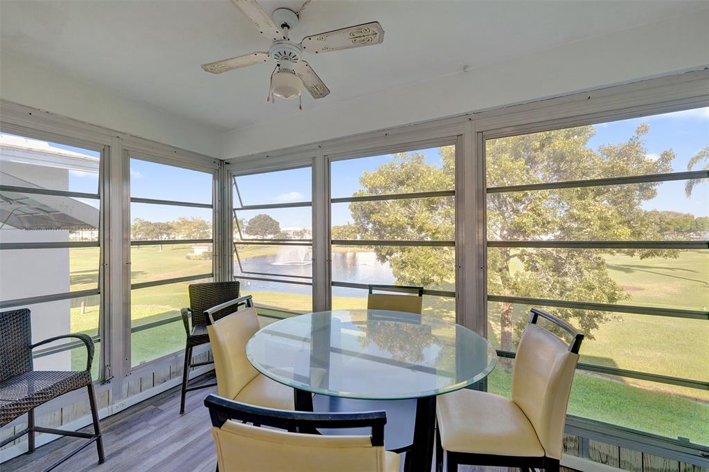 2751 East Golf Boulevard, Unit 2019 Pompano Beach, FL 33064 - Photo 38 of 68 a dining room with furniture window and wooden floor