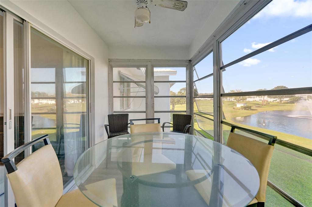 2751 East Golf Boulevard, Unit 2019 Pompano Beach, FL 33064 - Photo 39 of 68 a living room with furniture and floor to ceiling windows