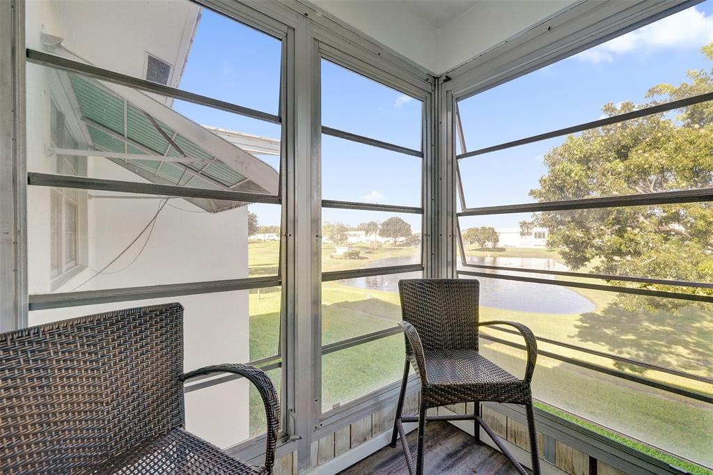 2751 East Golf Boulevard, Unit 2019 Pompano Beach, FL 33064 - Photo 40 of 68 a view of a chair and table in the balcony