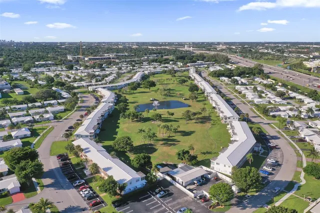 an aerial view of residential houses with outdoor space and river