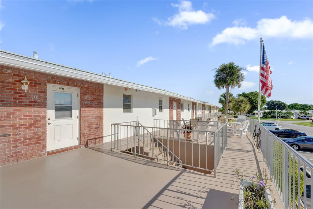 2751 East Golf Boulevard, Unit 2019 Pompano Beach, FL 33064 - Photo 45 of 68 a view of a house with backyard porch and sitting area