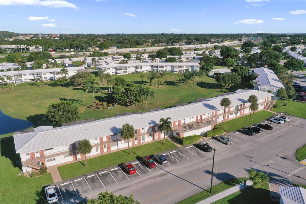 2751 East Golf Boulevard, Unit 2019 Pompano Beach, FL 33064 - Photo 48 of 68 an aerial view of a city with lots of residential buildings and mountain view in back