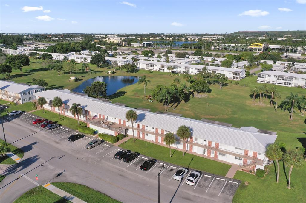 2751 East Golf Boulevard, Unit 2019 Pompano Beach, FL 33064 - Photo 5 of 68 an aerial view of a city with lots of residential buildings ocean and mountain view in back