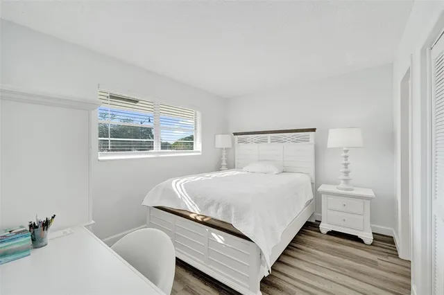 a bedroom with a large bed and a window