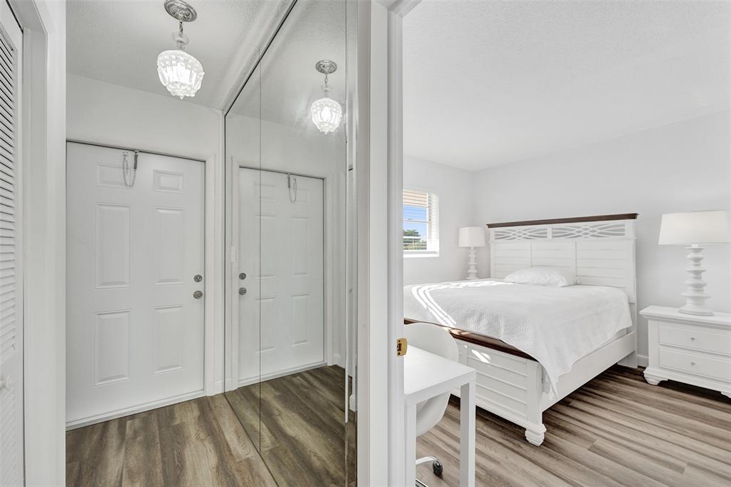 2751 East Golf Boulevard, Unit 2019 Pompano Beach, FL 33064 - Photo 62 of 68 a bedroom with a bed and a mirror