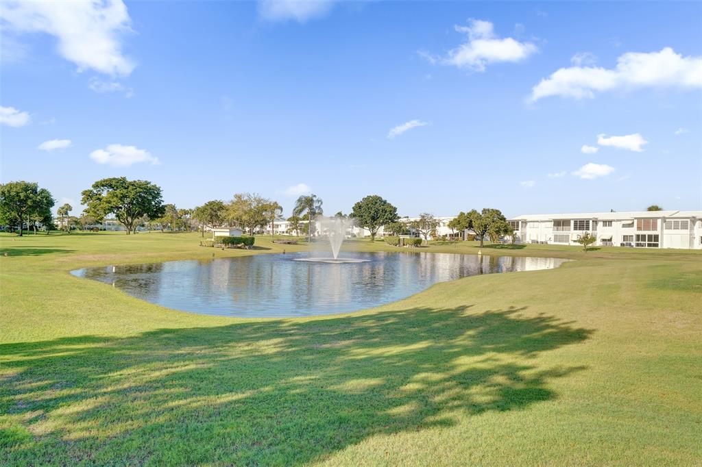 2751 East Golf Boulevard, Unit 2019 Pompano Beach, FL 33064 - Photo 68 of 68 a view of a lake with houses in the back