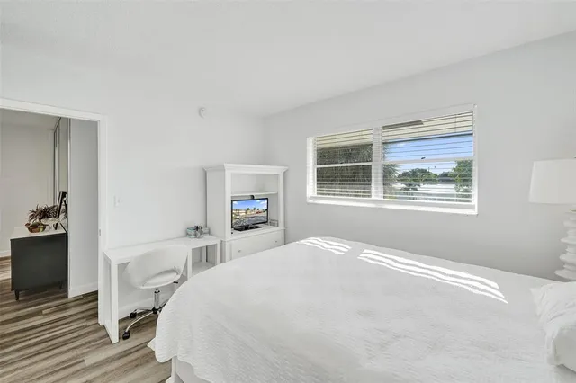 a bedroom with a large bed and a window