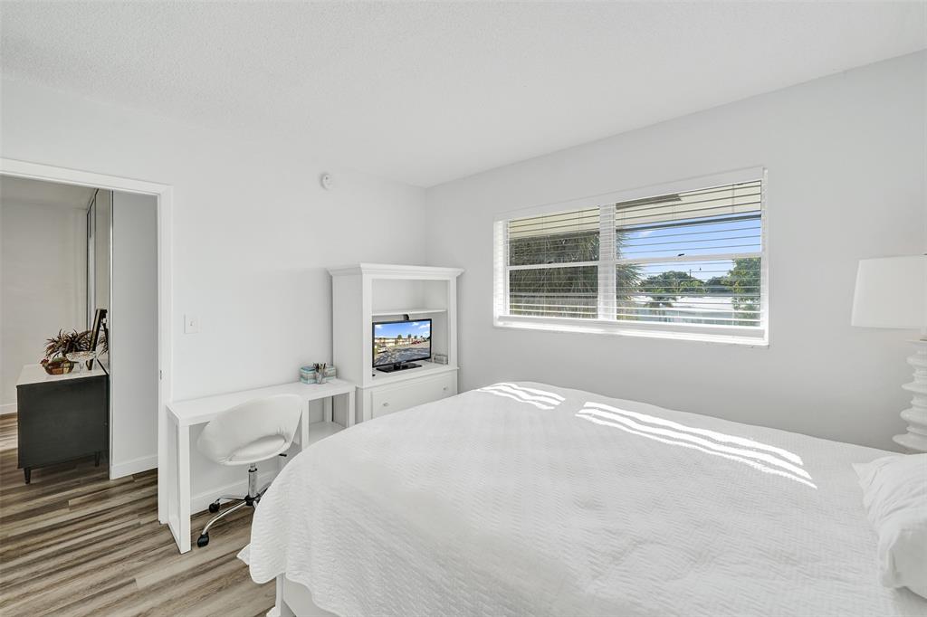 2751 East Golf Boulevard, Unit 2019 Pompano Beach, FL 33064 - Photo 10 of 68 a bedroom with a large bed and a window