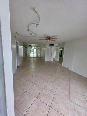a view of a hallway with chandelier