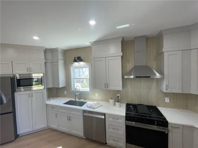 a kitchen that has a sink and a stove in it