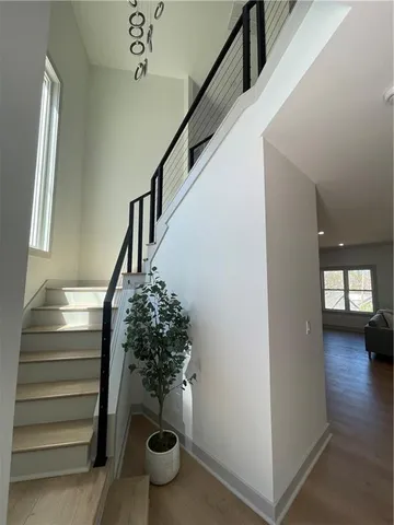 a view of entryway and hall with wooden floor