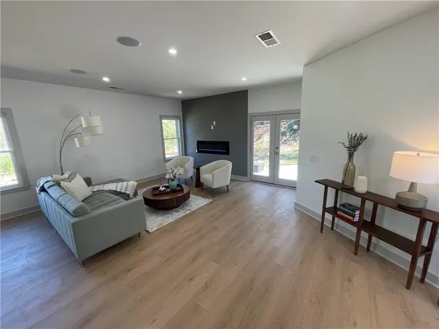 a living room with furniture and a wooden floor
