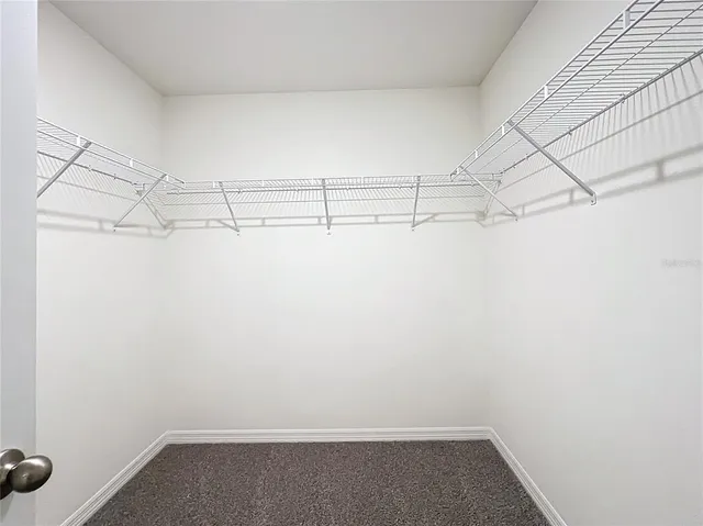 a view of a hallway with closet and wooden floor