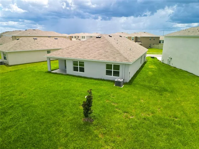 a view of a house with a backyard