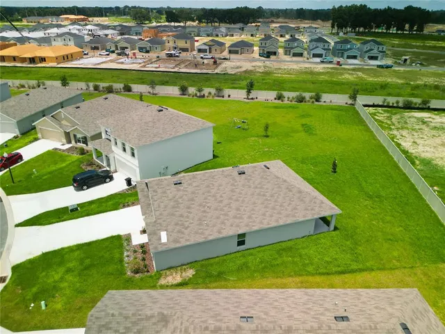 an aerial view of a house with a swimming pool yard and outdoor seating