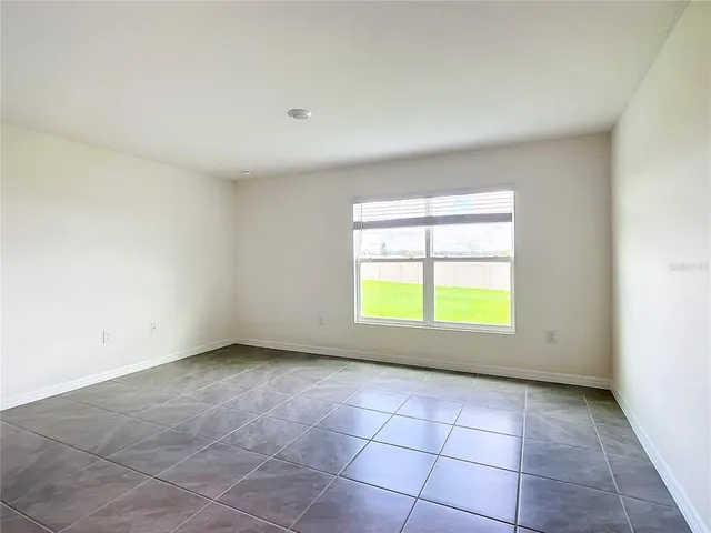 an empty room with a empty space and a window