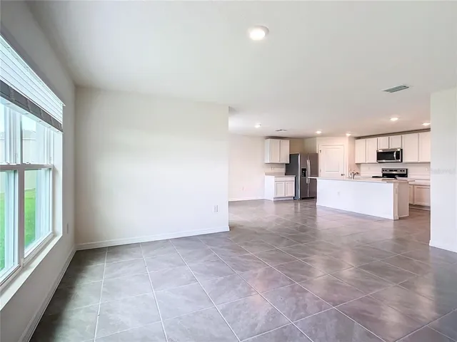 a view of a kitchen with a sink and a refrigerator