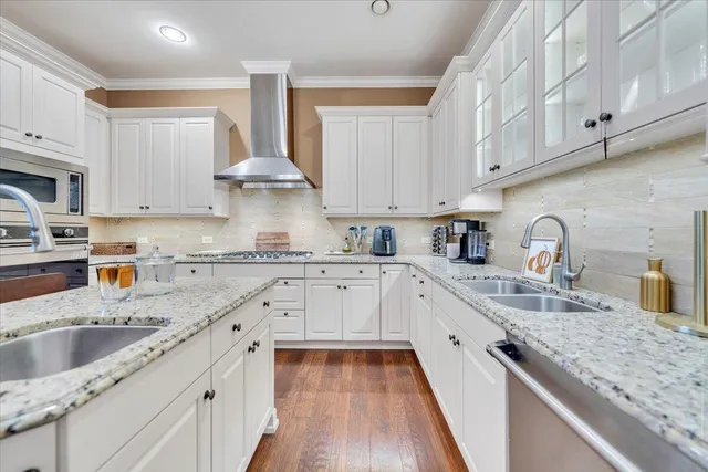 a kitchen with granite countertop a sink stainless steel appliances and cabinets