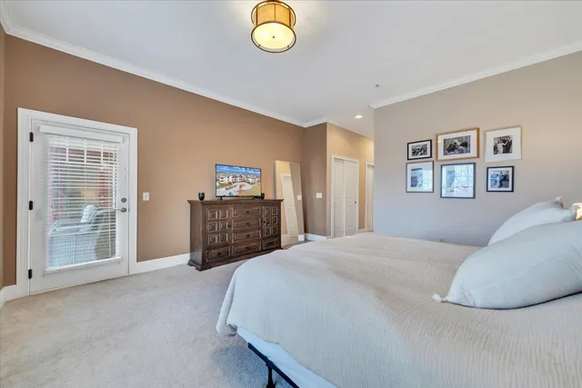 a spacious bedroom with a bed and dresser