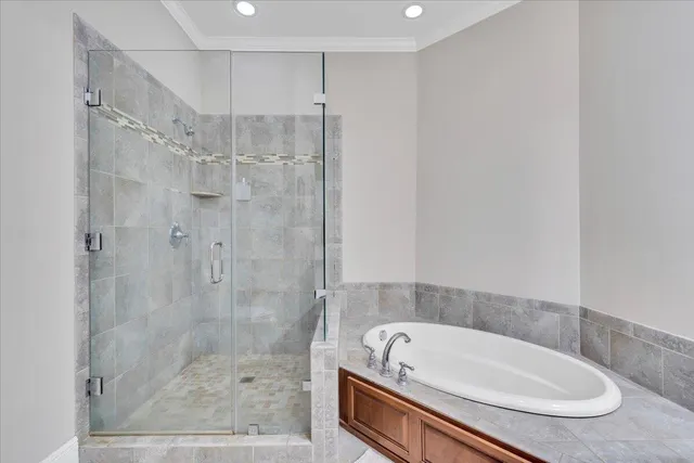 a bathroom with a tub a sink and a shower