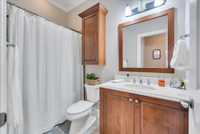 a bathroom with a toilet a sink and a mirror