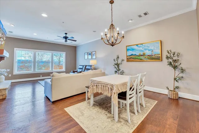 a view of a dining room with furniture wooden floor and chandelier