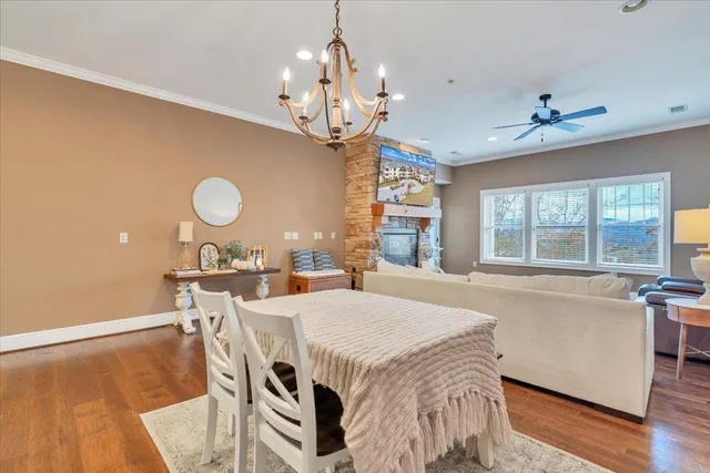 a view of a dining room with furniture a chandelier and wooden floor