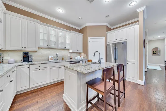 a kitchen with a sink cabinets and wooden floor
