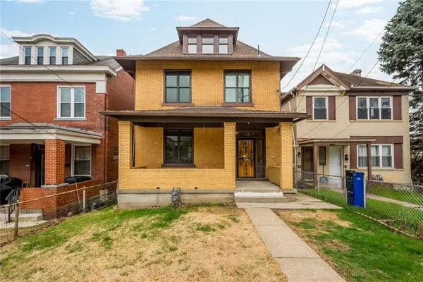 a front view of a house with a yard