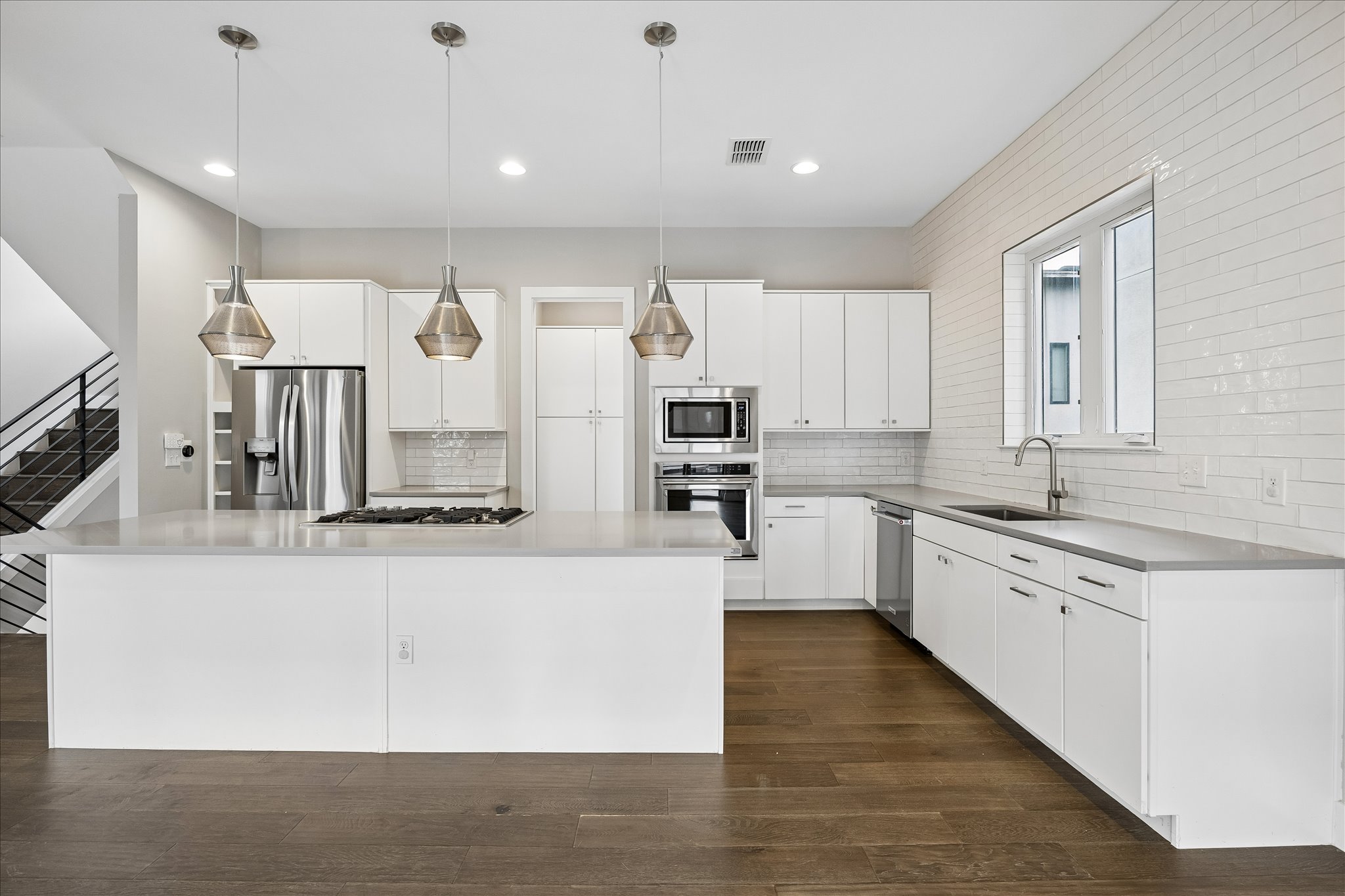 5006 Pecan Springs Road, Unit 6 Austin, TX 78723 - Photo 10 of 30 A well-appointed kitchen features a large island and contemporary stainless steel appliances, perfect for culinary adventures.