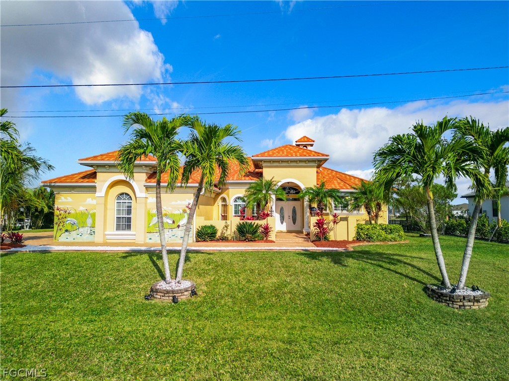 2115 Old Burnt Store Road North Cape Coral, FL 33993 - Photo 1 of 33 a view of a house with a yard and potted plants