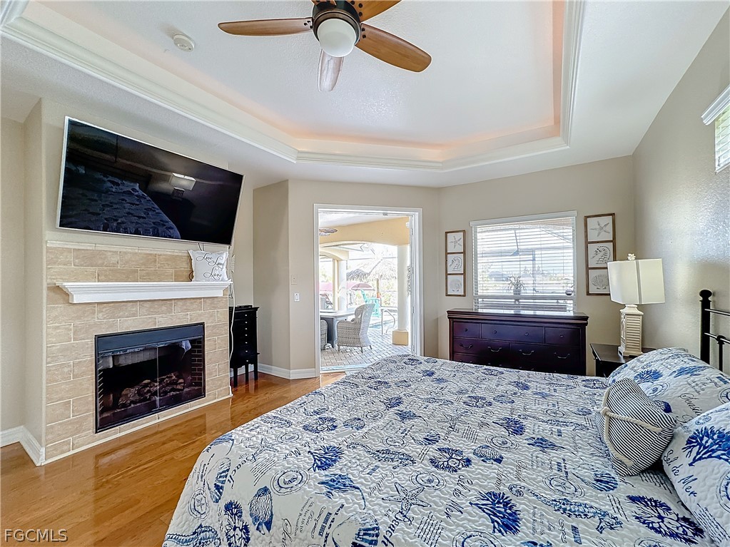 2115 Old Burnt Store Road North Cape Coral, FL 33993 - Photo 15 of 33 a bedroom with a bed and a fireplace