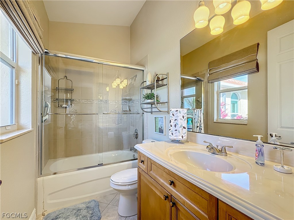 2115 Old Burnt Store Road North Cape Coral, FL 33993 - Photo 20 of 33 a bathroom with a shower sink vanity mirror and toilet