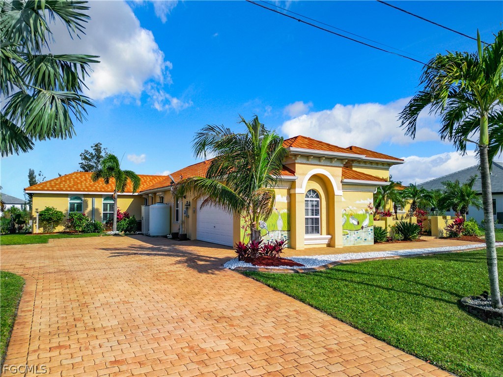 2115 Old Burnt Store Road North Cape Coral, FL 33993 - Photo 2 of 33 a front view of a house with a yard