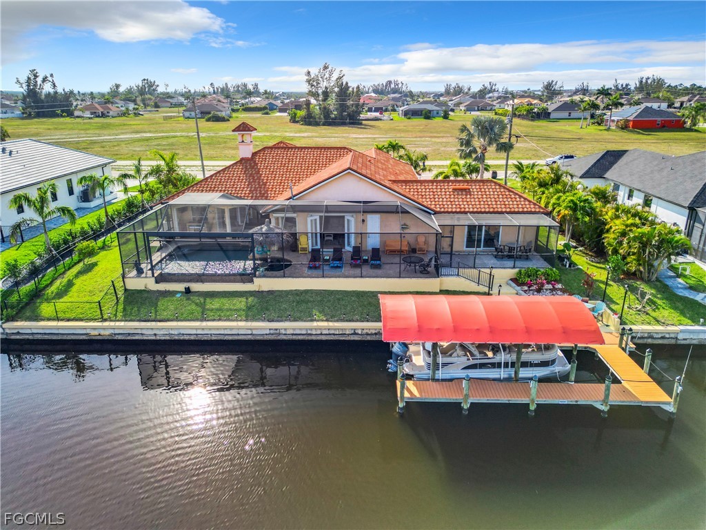 2115 Old Burnt Store Road North Cape Coral, FL 33993 - Photo 32 of 33 an aerial view of a house with a swimming pool a yard and lake view
