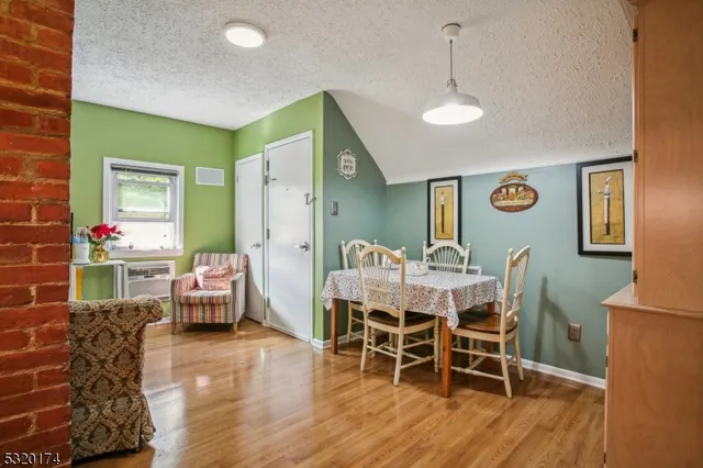 a dining room with furniture and wooden floor