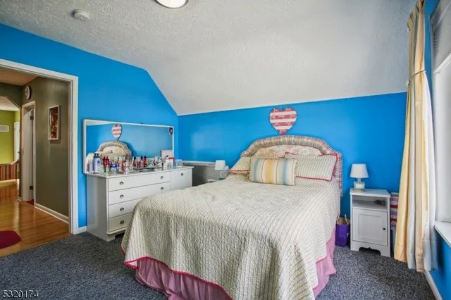 a bedroom with a bed and a table