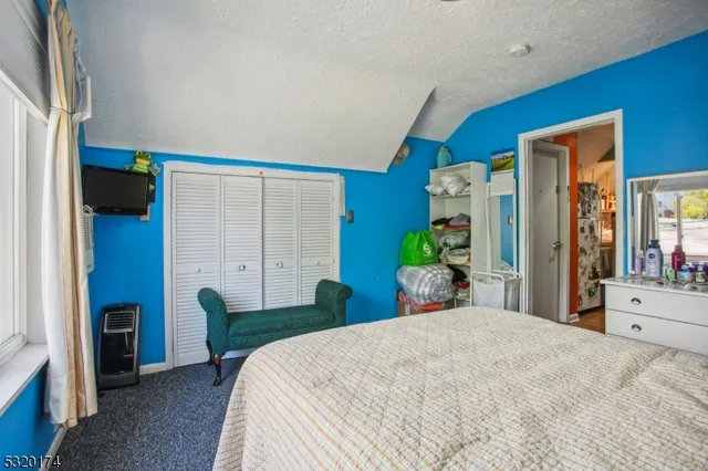 a bedroom with a bed and a large mirror