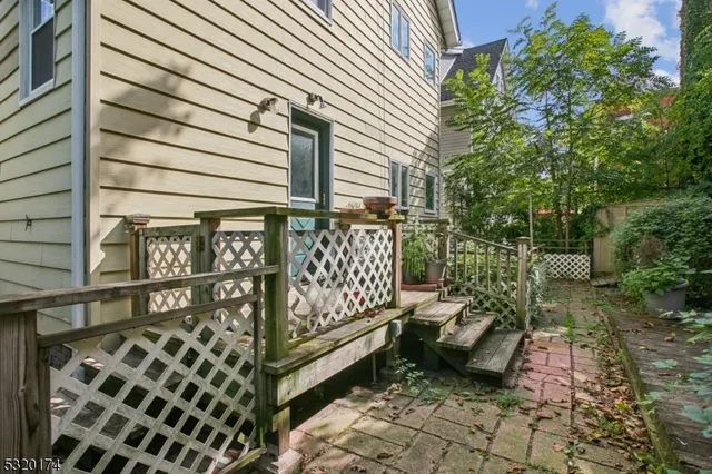 a balcony with a bench and white walls