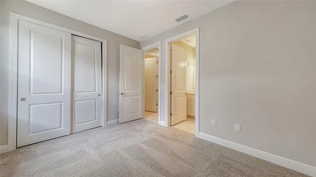 a view of an empty room with closet area