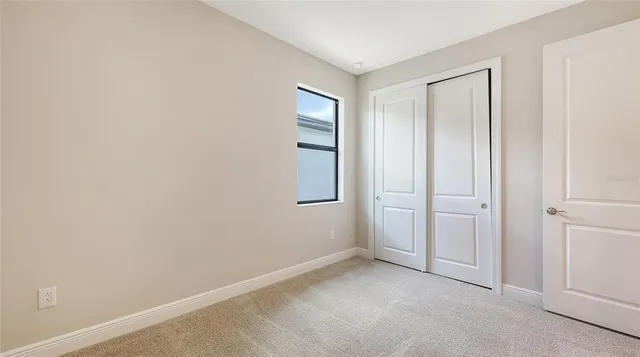 an empty room with windows and closet