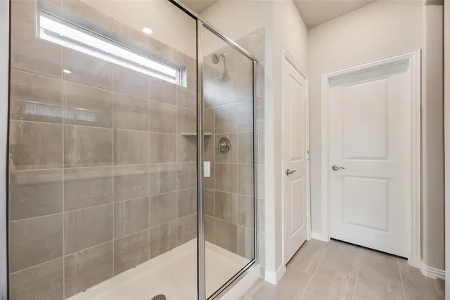a bathroom with a glass shower door