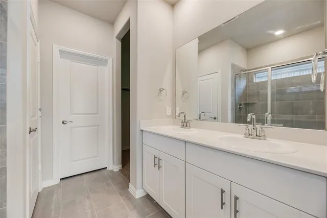 a bathroom with a sink double vanity and a mirror