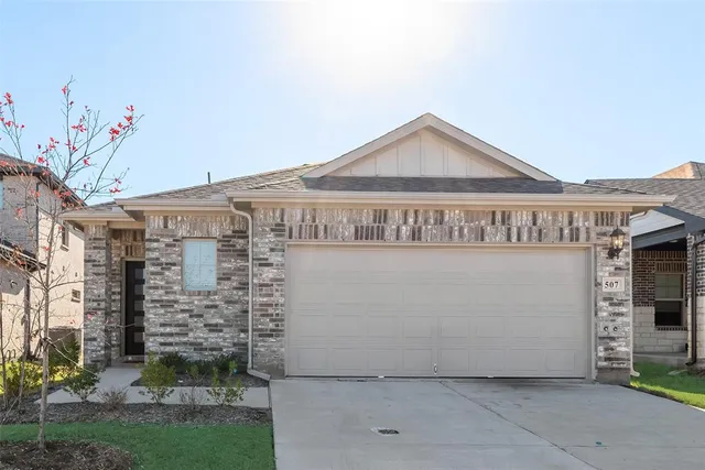 a view of a house with a yard and garage