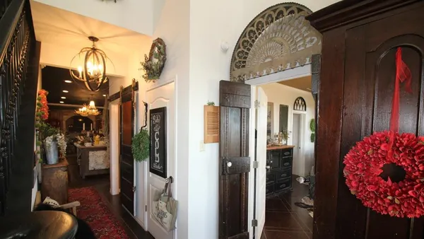 a living room with furniture and a chandelier