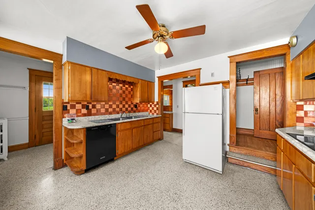 a kitchen with stainless steel appliances granite countertop a stove and a window